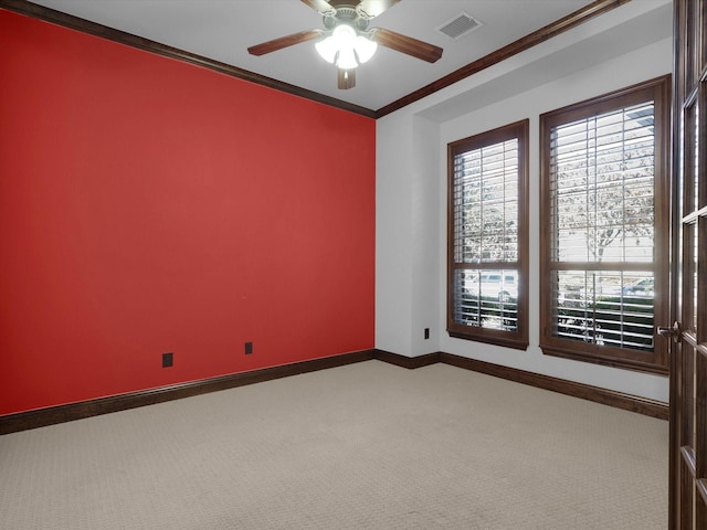 spare room featuring crown molding, carpet floors, and ceiling fan