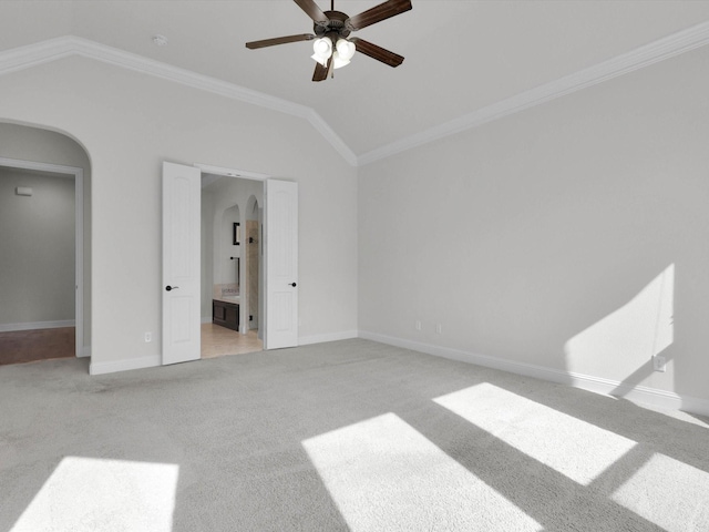 carpeted bedroom featuring lofted ceiling, connected bathroom, crown molding, and ceiling fan