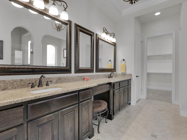 bathroom with crown molding, vanity, and tile patterned floors