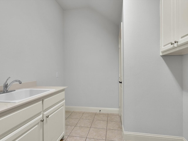 bathroom with vanity, baseboards, and tile patterned flooring