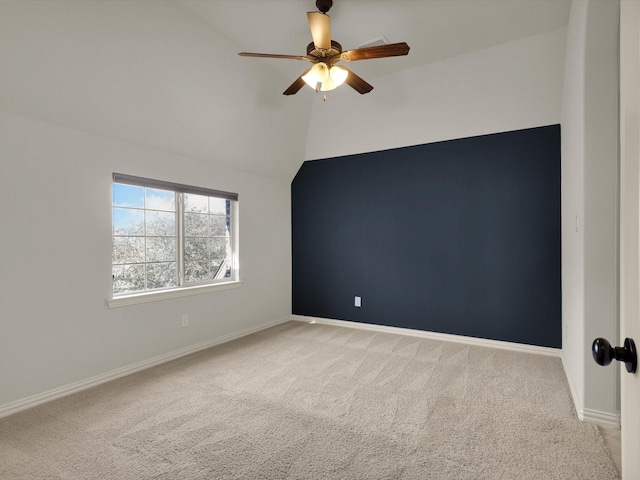 carpeted empty room with baseboards, a ceiling fan, and lofted ceiling
