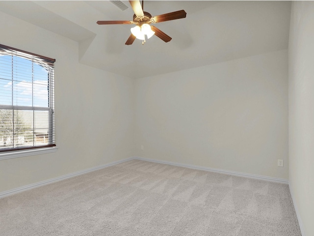 spare room with ceiling fan and light carpet