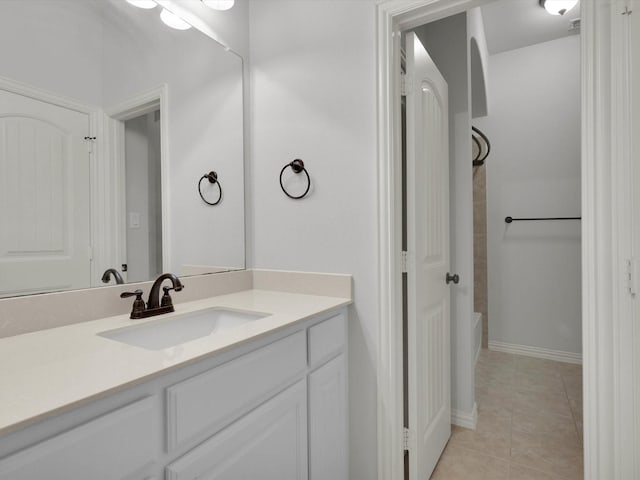 bathroom with baseboards, vanity, tile patterned floors, and shower / bathing tub combination