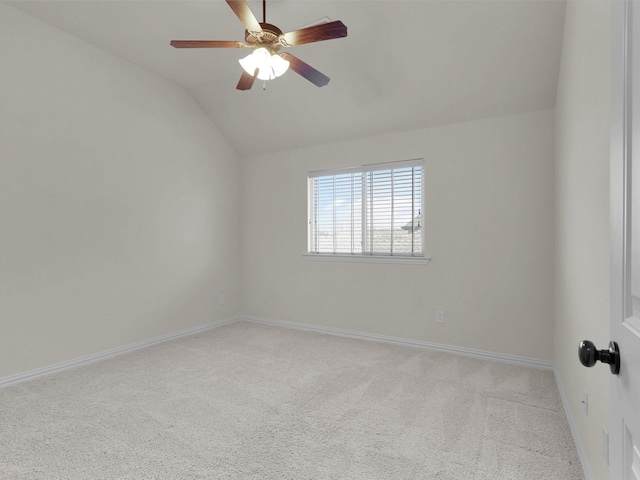 empty room featuring ceiling fan, light colored carpet, and vaulted ceiling