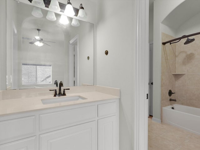 bathroom with tiled shower / bath, tile patterned floors, ceiling fan, and vanity