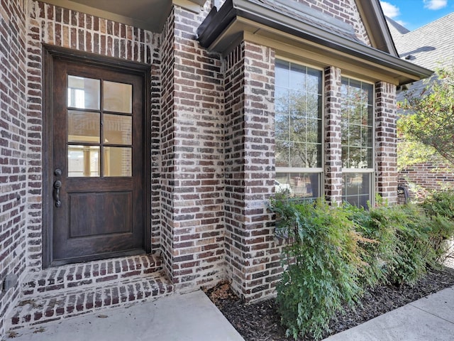 property entrance with brick siding