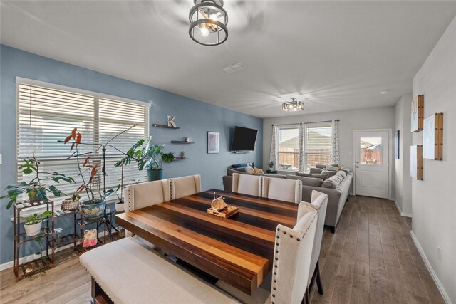 dining space with hardwood / wood-style flooring