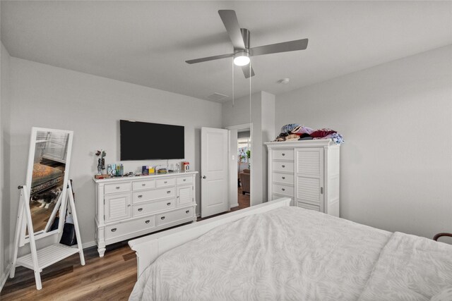 bedroom with ceiling fan and dark hardwood / wood-style flooring