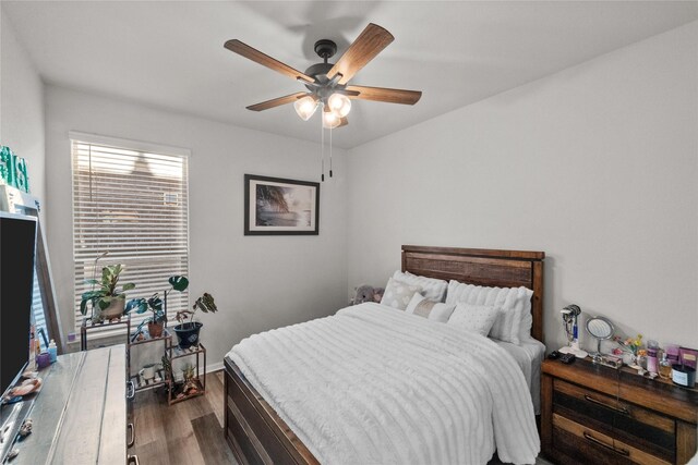 bedroom with ceiling fan and dark hardwood / wood-style floors