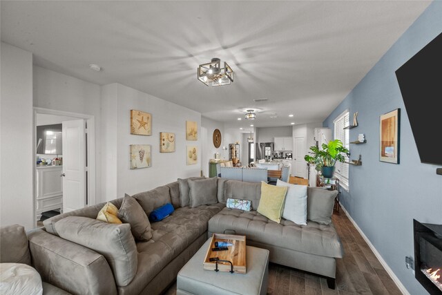 living room with dark hardwood / wood-style flooring