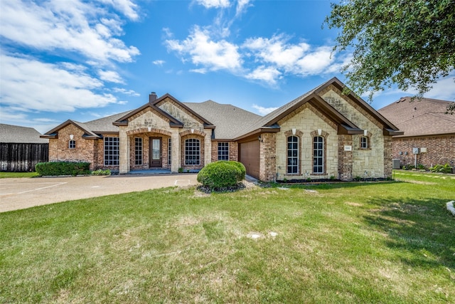 view of front of home with a garage and a front yard