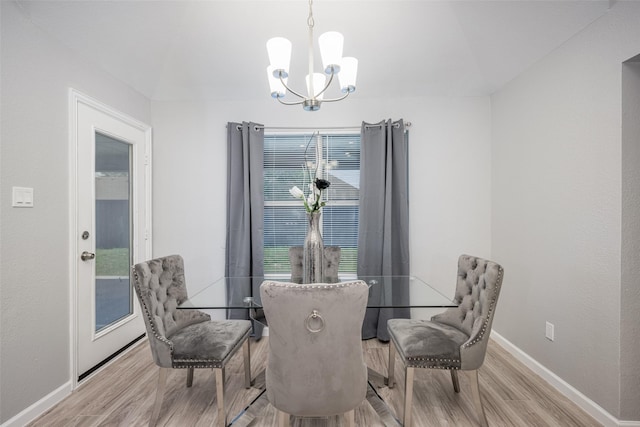 dining room with a notable chandelier and light wood-type flooring