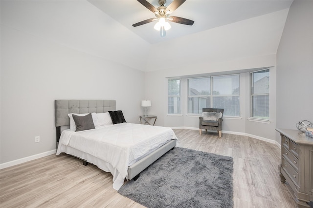 bedroom with ceiling fan, lofted ceiling, and light hardwood / wood-style floors