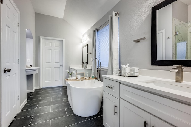 bathroom with vanity, vaulted ceiling, and shower with separate bathtub