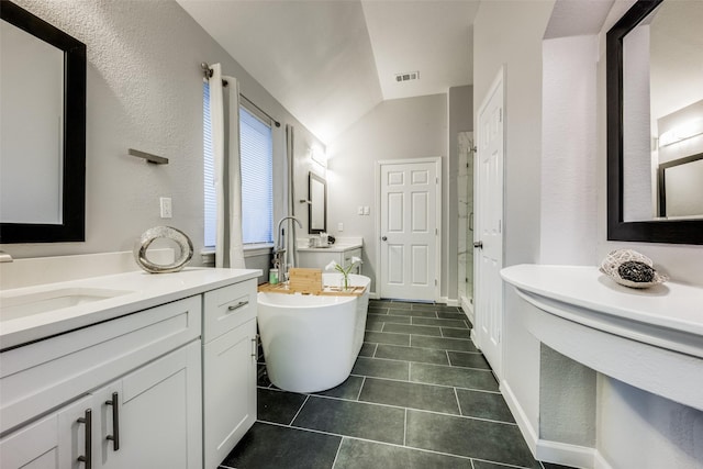 bathroom featuring tile patterned flooring, vanity, vaulted ceiling, and plus walk in shower