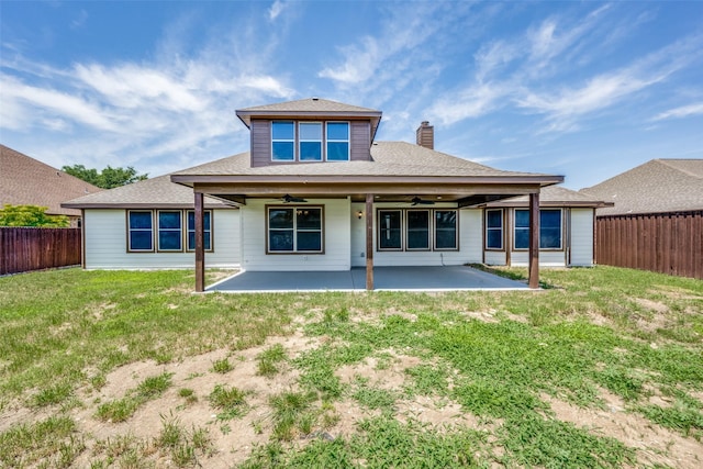 back of property featuring a yard, a patio, and ceiling fan