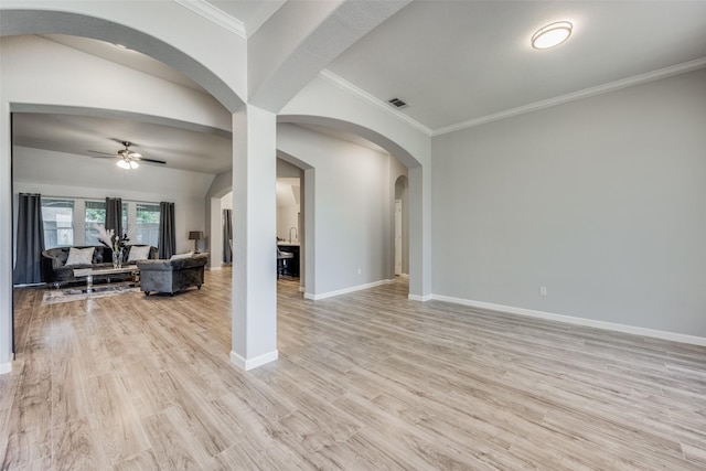 living room featuring crown molding, ceiling fan, and light wood-type flooring