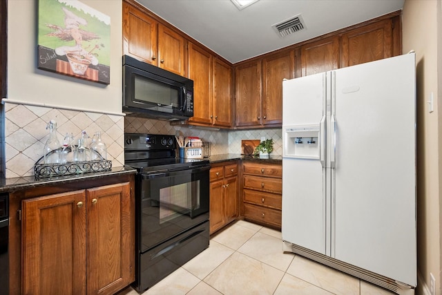 kitchen with dark stone countertops, light tile patterned floors, backsplash, and black appliances