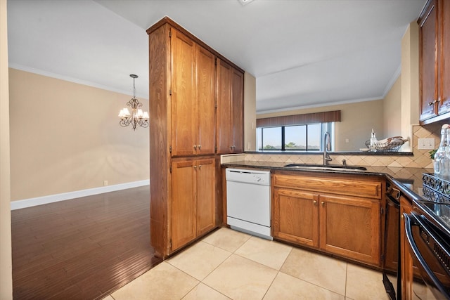 kitchen featuring dishwasher, sink, backsplash, and crown molding