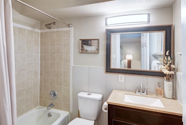 full bathroom with shower / tub combo, vanity, a textured ceiling, and toilet