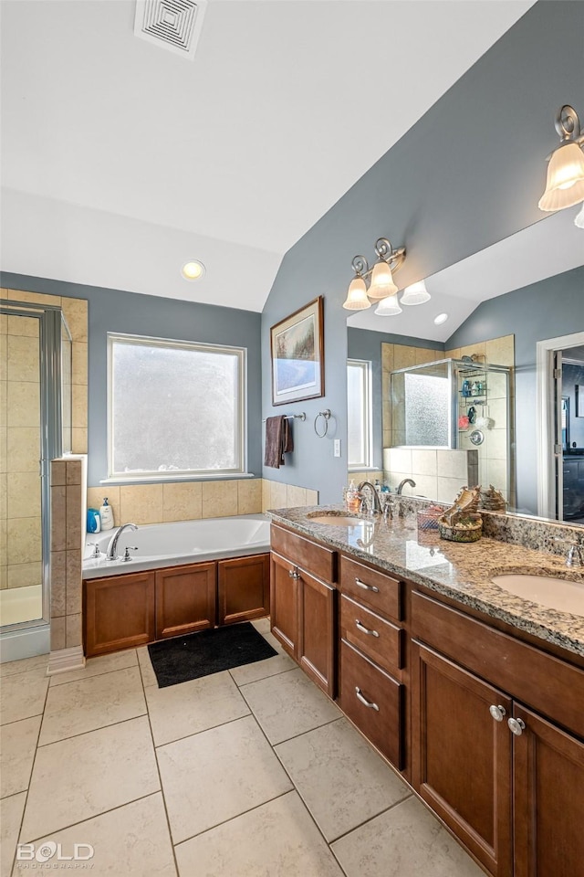 bathroom with vaulted ceiling, separate shower and tub, tile patterned floors, and vanity