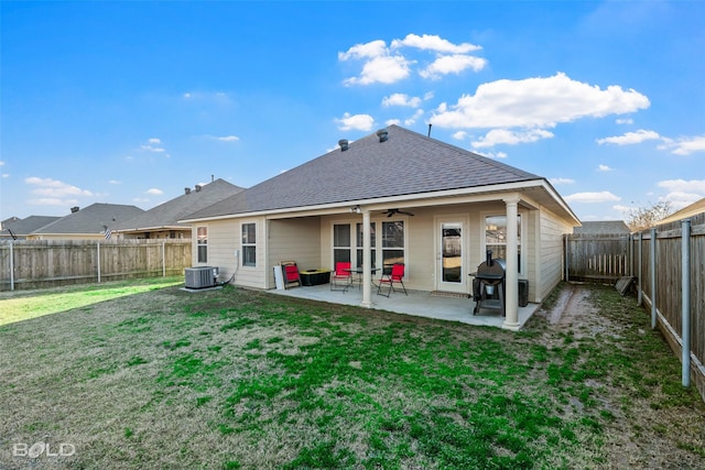 rear view of property with ceiling fan, a yard, a patio, and central air condition unit