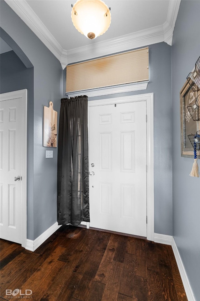 entrance foyer with dark wood-type flooring and ornamental molding