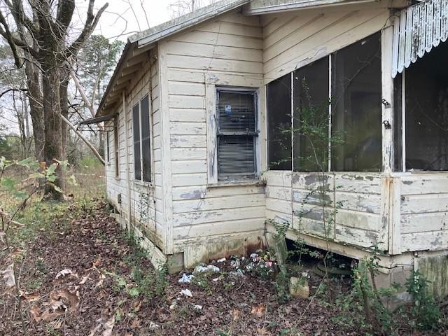 view of property exterior featuring a sunroom