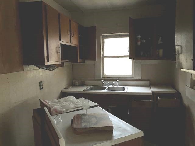 kitchen featuring dark brown cabinetry and sink