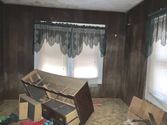 dining room with wood walls