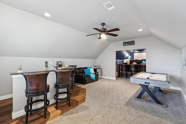 carpeted home office featuring vaulted ceiling and ceiling fan