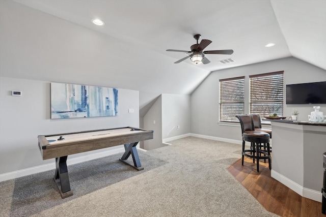 recreation room with vaulted ceiling, ceiling fan, and carpet flooring