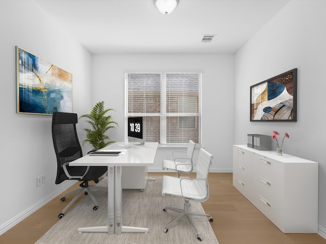 office space with light wood-type flooring