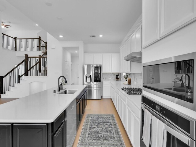 kitchen with pendant lighting, light hardwood / wood-style flooring, white cabinets, stainless steel fridge with ice dispenser, and a chandelier