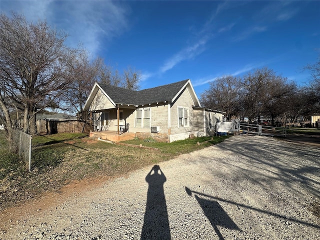 view of side of home with covered porch