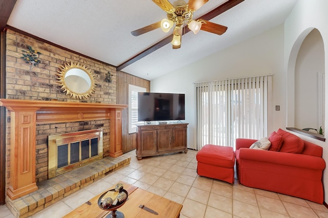 tiled living room featuring ceiling fan, vaulted ceiling, and a brick fireplace