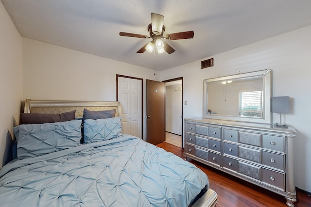 bedroom with dark hardwood / wood-style floors and ceiling fan