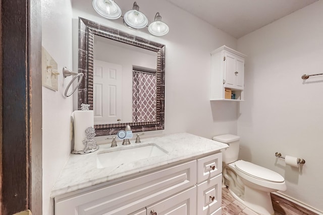 bathroom featuring vanity, wood-type flooring, walk in shower, and toilet