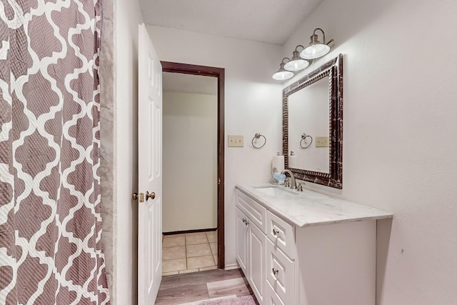 bathroom with vanity and wood-type flooring