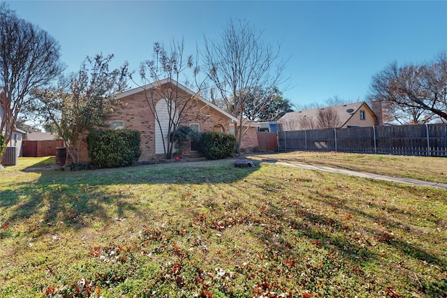 view of side of property featuring a yard