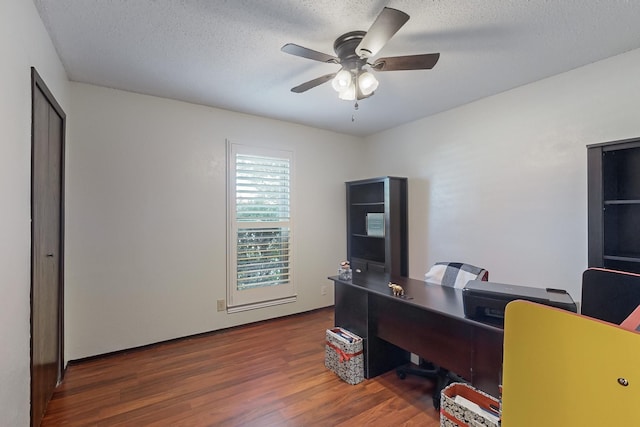 office area featuring a textured ceiling, dark hardwood / wood-style floors, and ceiling fan