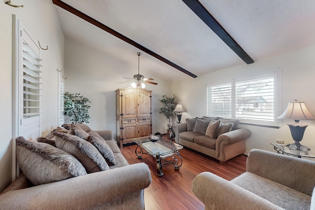 living room featuring lofted ceiling with beams, dark hardwood / wood-style floors, and ceiling fan