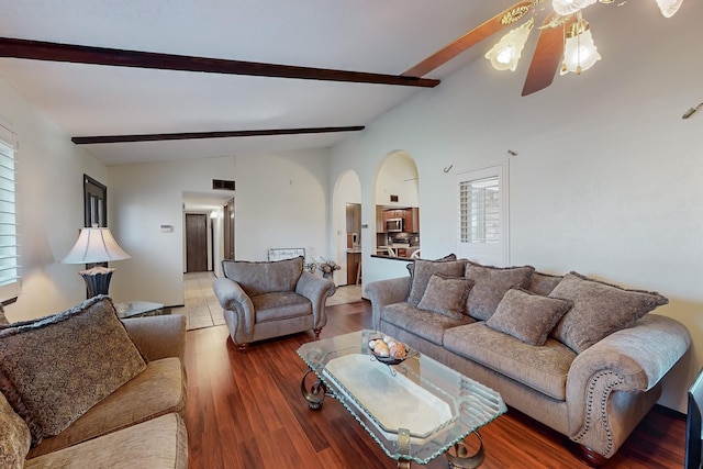 living room featuring ceiling fan, dark hardwood / wood-style flooring, and lofted ceiling with beams