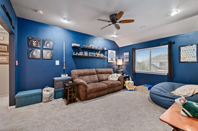 carpeted living room with ceiling fan and lofted ceiling