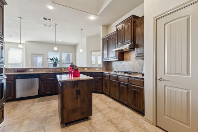 kitchen featuring stainless steel appliances, decorative light fixtures, a center island, and dark brown cabinets