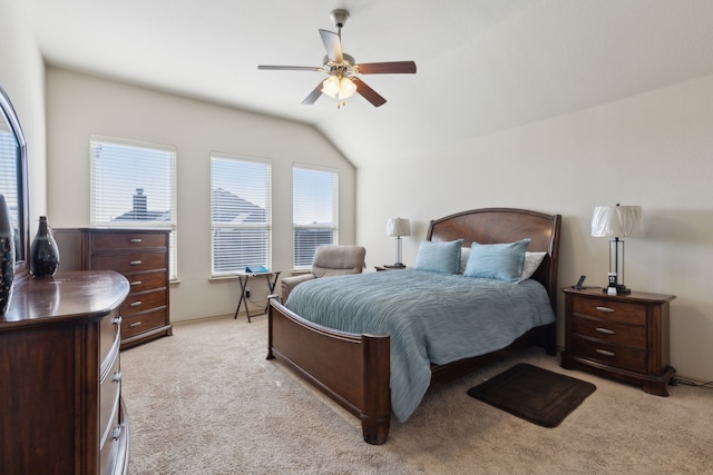 carpeted bedroom with vaulted ceiling and ceiling fan