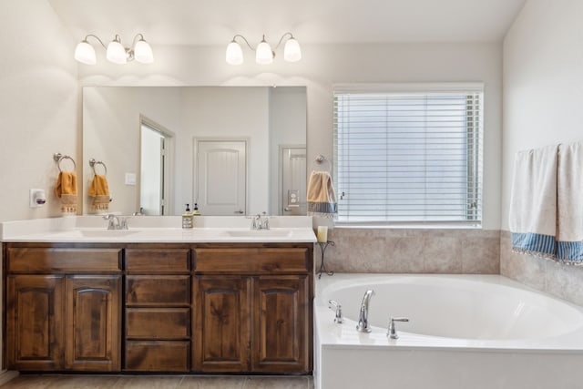 bathroom with vanity and a washtub