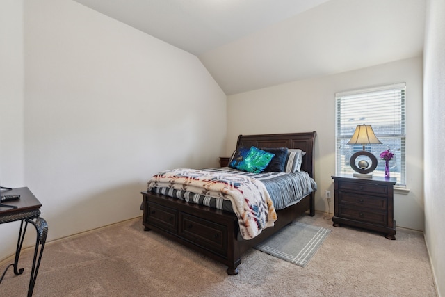 bedroom featuring lofted ceiling and light colored carpet