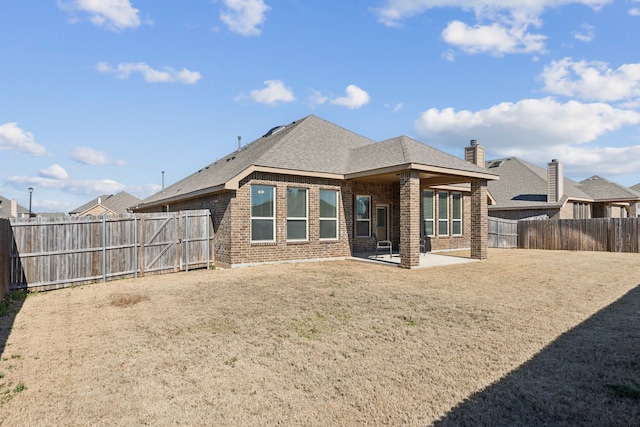 back of house featuring a yard and a patio