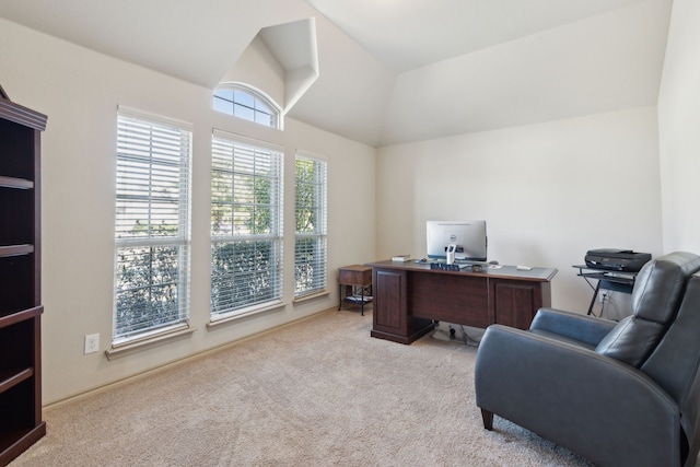 carpeted home office with lofted ceiling